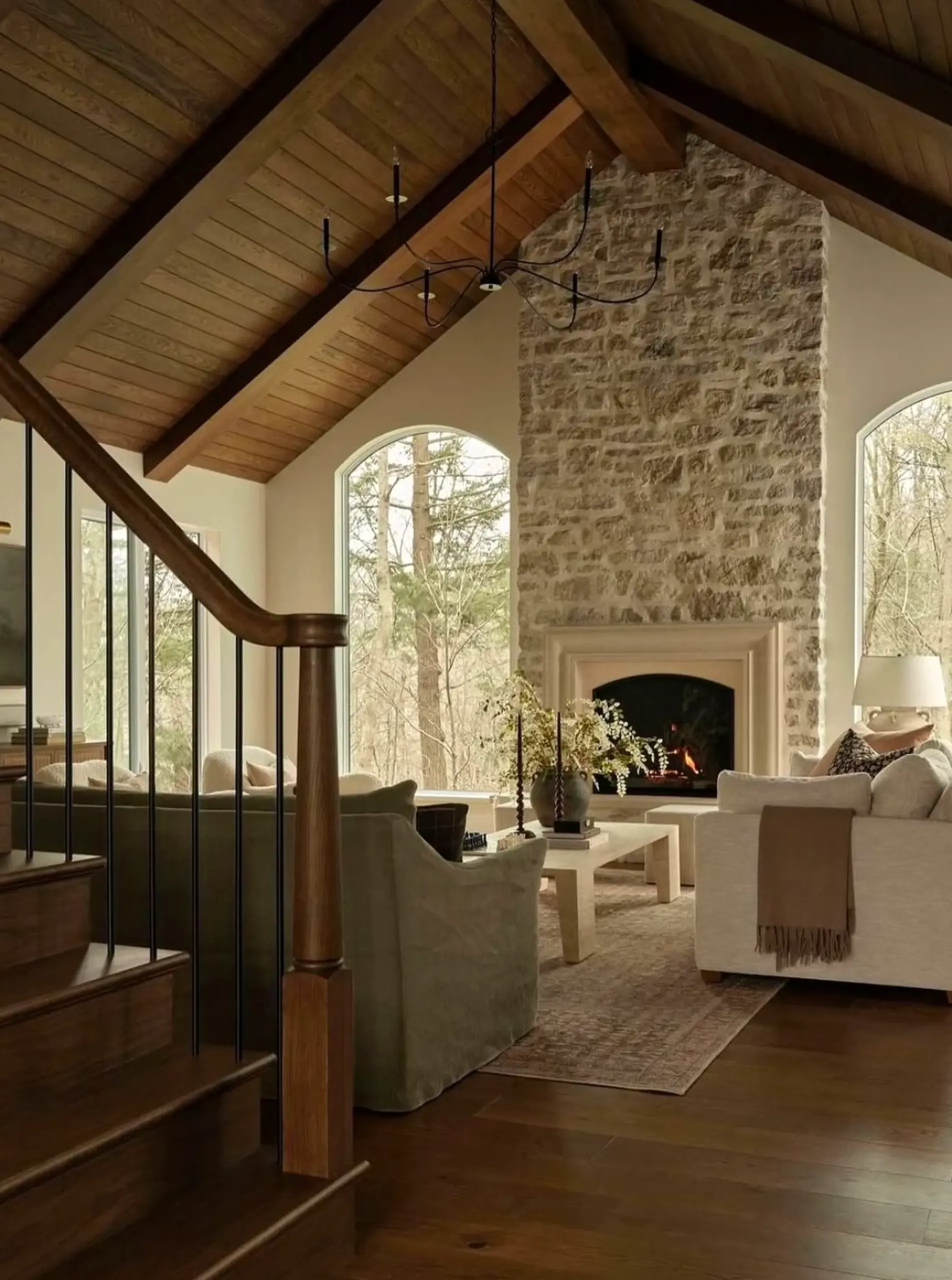 Layered neutral bedroom introduces shape into the corner, keeping the atmosphere warm without clutter.