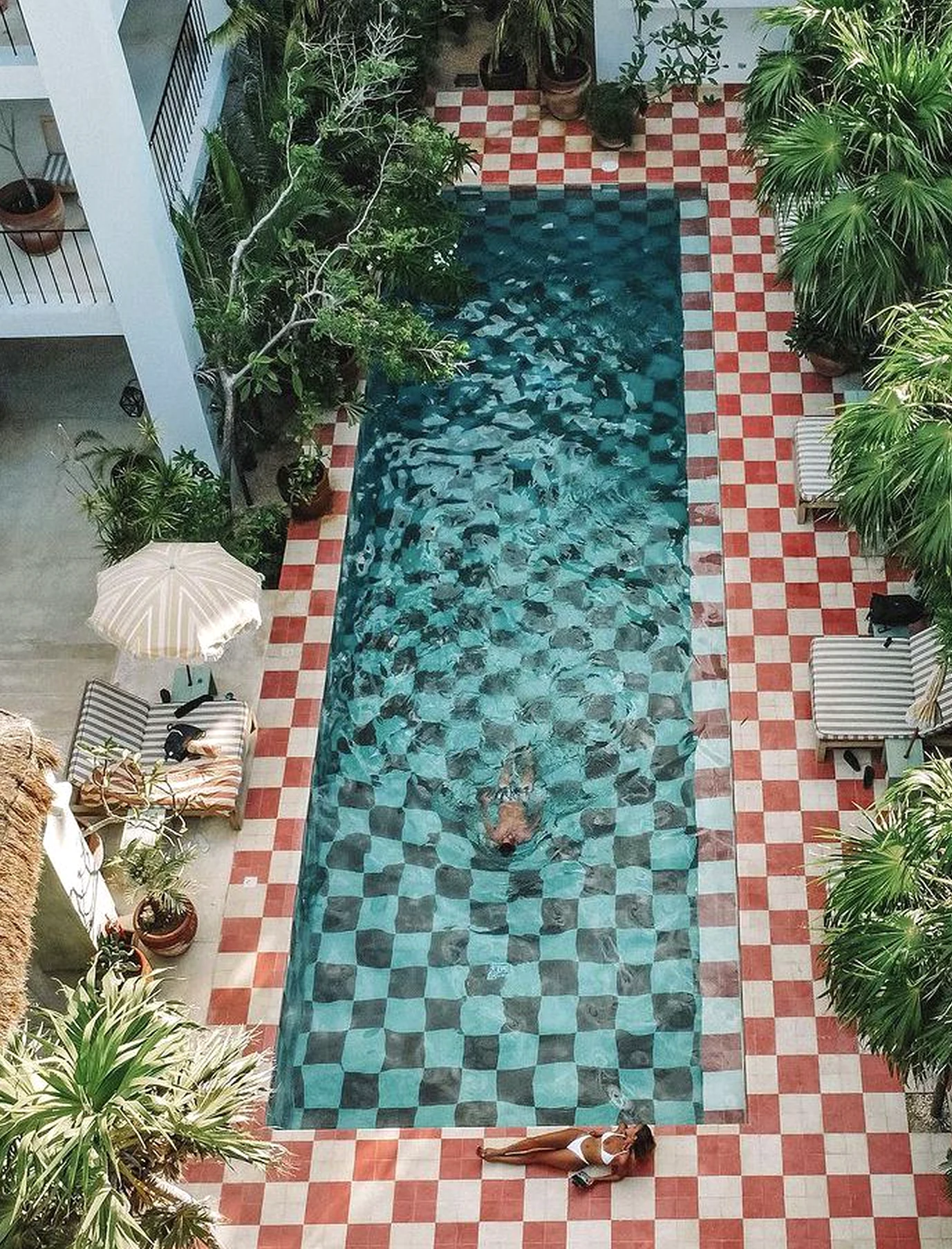 Leafy balcony scene brings a useful note of charm, making the entry feel open and lived-in.